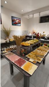 a buffet line with many different types of food at Art Royal in Tashkent