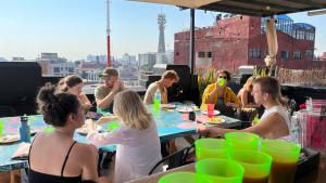 a group of people sitting at a table on a roof at Massiosare El Hostal in Mexico City