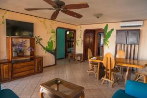 a living room with a table and a tv at Host Company Jaco Luxury in Jacó