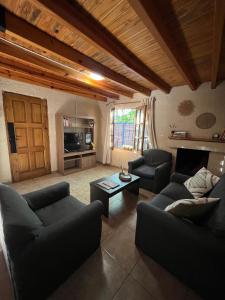 a living room with two couches and a table at Rincón Las Hiedras in Chacras de Coria