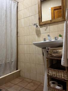 a bathroom with a sink and a shower at Rincón Las Hiedras in Chacras de Coria +17 photos
