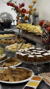a buffet filled with lots of different types of desserts at Art Royal in Tashkent +37 photos
