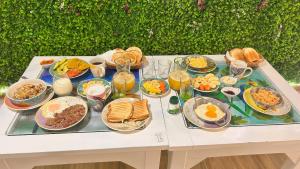 a table filled with plates of food and drinks at Posada Martha Tolima in Salento