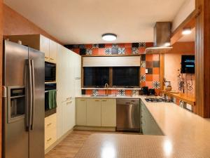 a kitchen with a stainless steel refrigerator at Hidden Gem in the CBD in Coffs Harbour
