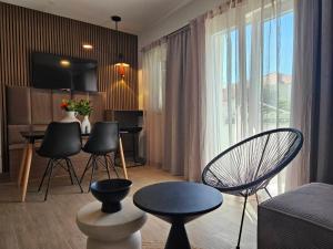 a living room with chairs and a table and a couch at Brand New seaside Apartments NOA & JAKOV, Zaboric Sibenik in Zaboric
