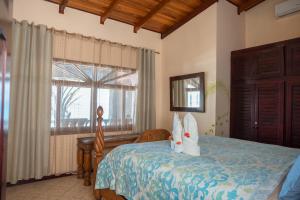 a bedroom with a bed and a window at Host Company Jaco Luxury in Jacó +156 photos