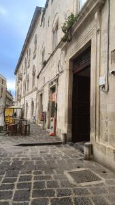 a building with a door on the side of a street at Archimede29 in Syracuse +83 photos