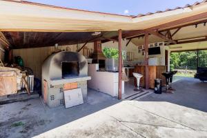 an outdoor kitchen with an oven in a house at Chácara Caminho do Rio in Morretes +84 photos