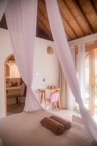 a bedroom with a bed with a wooden ceiling at Villa Nyantara - Private tropical villa in Gili Islands +36 photos