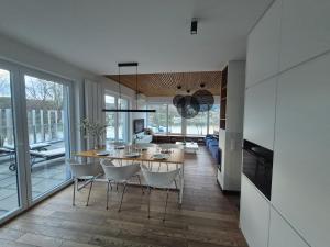 a dining room and living room with a table and chairs at LakeView 59 Lemon Resort Spa in Gródek Nad Dunajcem