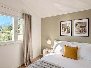 a bedroom with a white bed and a window at Villa Vedran in Podgora +35 photos