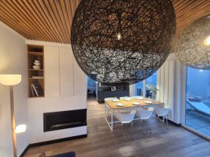 a dining room with a table and a large chandelier at LakeView 59 Lemon Resort Spa in Gródek Nad Dunajcem +95 photos