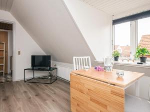 a living room with a table and a television at 2 person holiday home in Ringkøbing in Ringkøbing