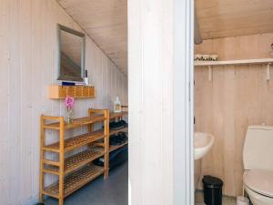 a bathroom with a sink and a toilet and a mirror at 8 person holiday home in Sydals in Neder Lysabild +38 photos