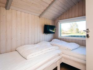 two beds in a room with a window at 8 person holiday home in Sydals in Neder Lysabild
