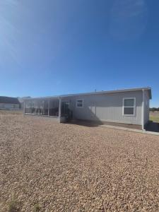 a building with a gravel yard in front of it at Rural Farmhouse in Taylor