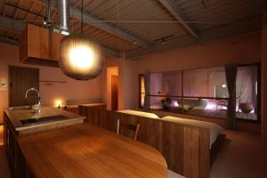 a kitchen and dining room with a wooden table at たゆら in Nara