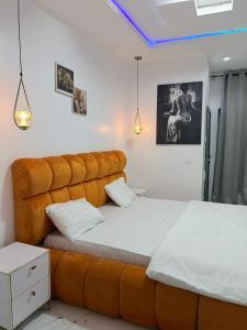a bedroom with two beds with a large headboard at Candy horizon height homes in Ikate