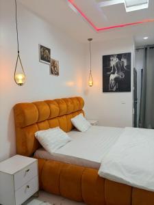 a bedroom with a large bed with a large headboard at Candy horizon height homes in Ikate +30 photos