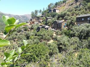 a village on the side of a mountain at Casa da Encosta - Piódão in Piódão +16 photos