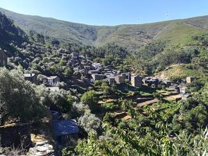a small village in a valley in the mountains at Casa da Encosta - Piódão in Piódão