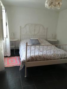 a bed in a bedroom with two tables at Casa da Encosta - Piódão in Piódão