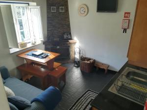 a living room with a couch and a table at Casa da Encosta - Piódão in Piódão