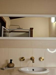 a bathroom with a sink and a mirror at 12 Apostles Cottages - Tullarook in Princetown