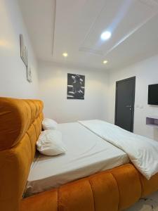 a bedroom with a large bed and a couch at Candy horizon height Apartemnt in Ikate +25 photos