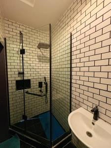 a bathroom with a shower and a sink at Candy horizon height Apartemnt in Ikate