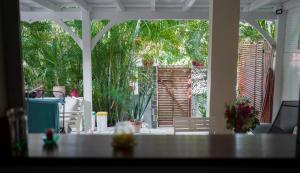 a living room with a view of a patio at Janelle in Le Diamant