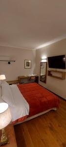 a bedroom with a bed and a flat screen tv at Chiesina di Montesperello in Pantanella