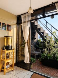 a balcony with a glass door with a curtain at Mazaryk Bed and Breakfast in Antigua Guatemala +12 photos