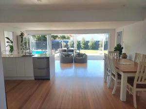 a kitchen and dining room with a table and a dining room at Inner city Sanctuary in Gisborne