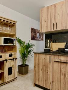 a kitchen with wooden cabinets and a counter top at Casa Natali in Fuengirola
