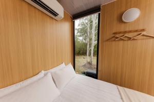a bedroom with a large bed and a window at The Tiny Chalet by Tiny Away in Bromfleet