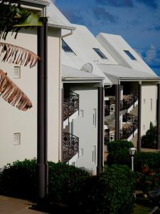 a building with balconies on the side of it at Petite Ancre in Le Gosier