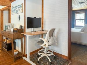 a desk with a computer and a chair in a room at Ultimate Hayward Trailhead Cabin - Base Camp 77 in Hayward +27 photos