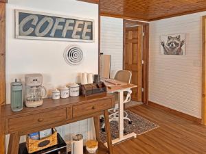 a coffee shop with a wooden table in a room at Ultimate Hayward Trailhead Cabin - Base Camp 77 in Hayward