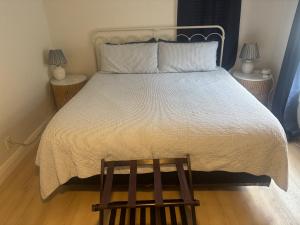 a bedroom with a large bed with a wooden floor at Seaside Retreat Cottages #1 in Clearwater Beach +29 photos
