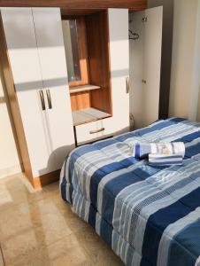 a bedroom with a blue and white bed with towels on it at Residencia Multifamiliar Sammy in Trujillo