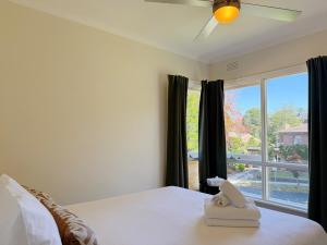 a bedroom with a bed and a large window at Doncaster Westfiled House 4BD in Doncaster