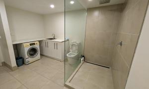 a bathroom with a toilet and a washing machine at Doncaster Westfiled House 4BD in Doncaster +5 photos