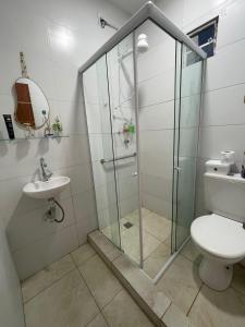 a bathroom with a shower and a toilet and a sink at New House Temporada in João Pessoa