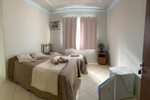 a bedroom with two beds and a window at Hotel Eldorado de Salinas in Salinas +6 photos