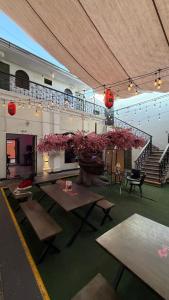 a large room with tables and a large tree with pink flowers at UMAI Palace in Arequipa