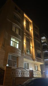 a tall building with a fence in front of it at Egy property in 6th Of October