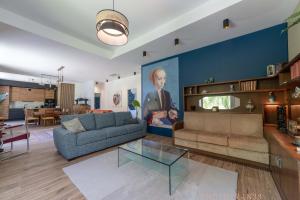 a living room with a couch and a table at Le 10, Reflets dans l'Eau in Saint-Clair-de-la-Tour
