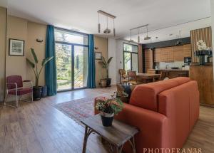 a living room with a couch and a table at Le 10, Reflets dans l'Eau in Saint-Clair-de-la-Tour