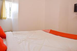 a bed in a room with an orange and white mattress at Super Collection O Sayhallo Kanchan in Bhubaneshwar